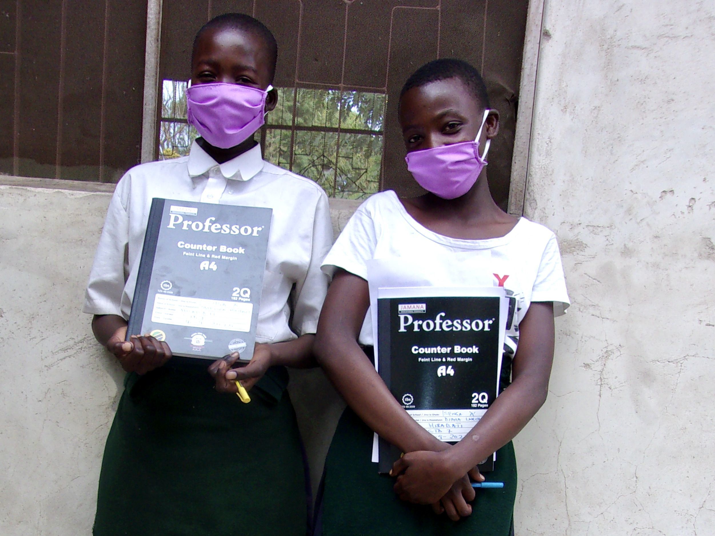 Tanzanian students return to school with masks.